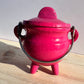 A pink cauldron.