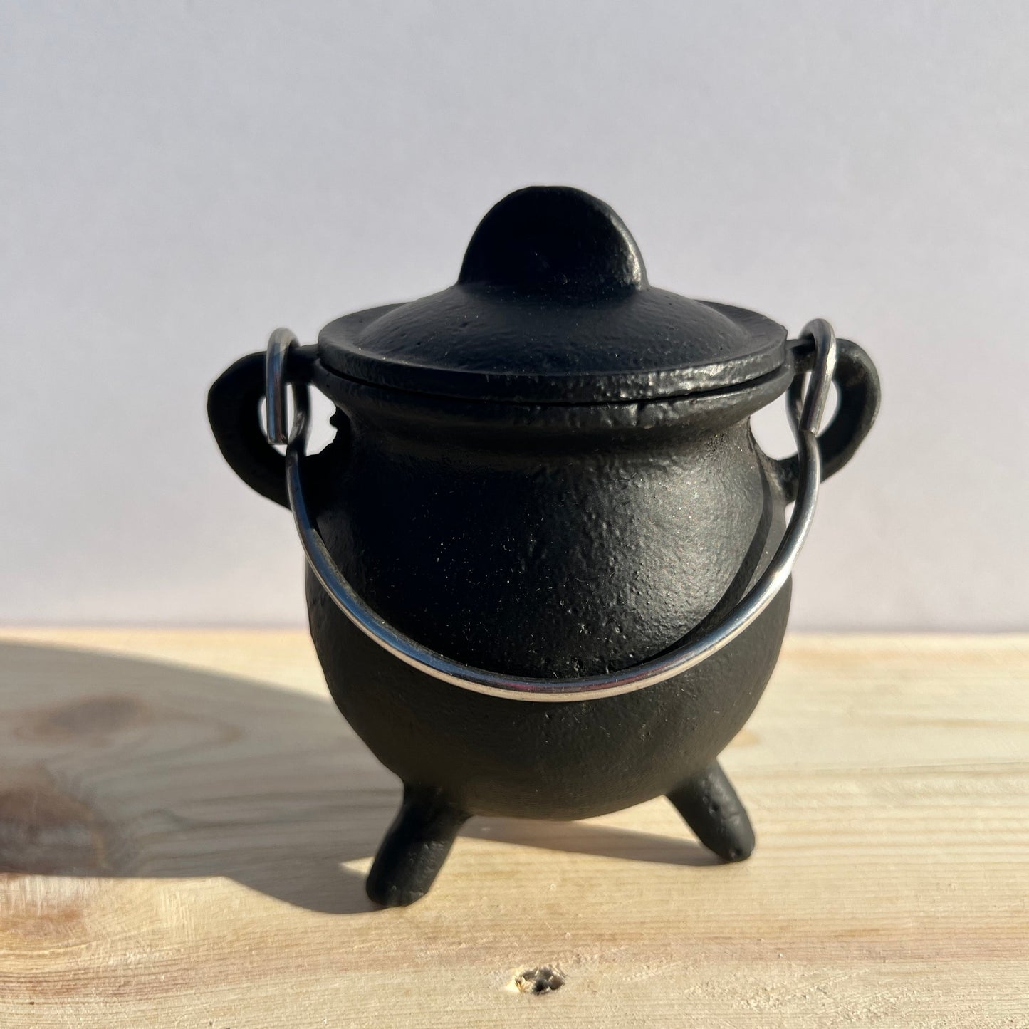 A black, cast iron, potbelly cauldron.