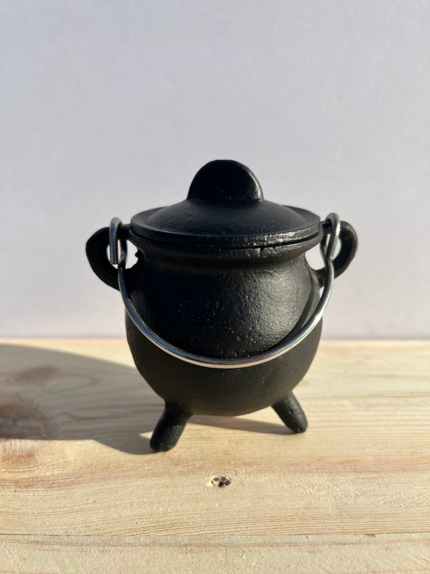 A potbelly cauldron with a handle.