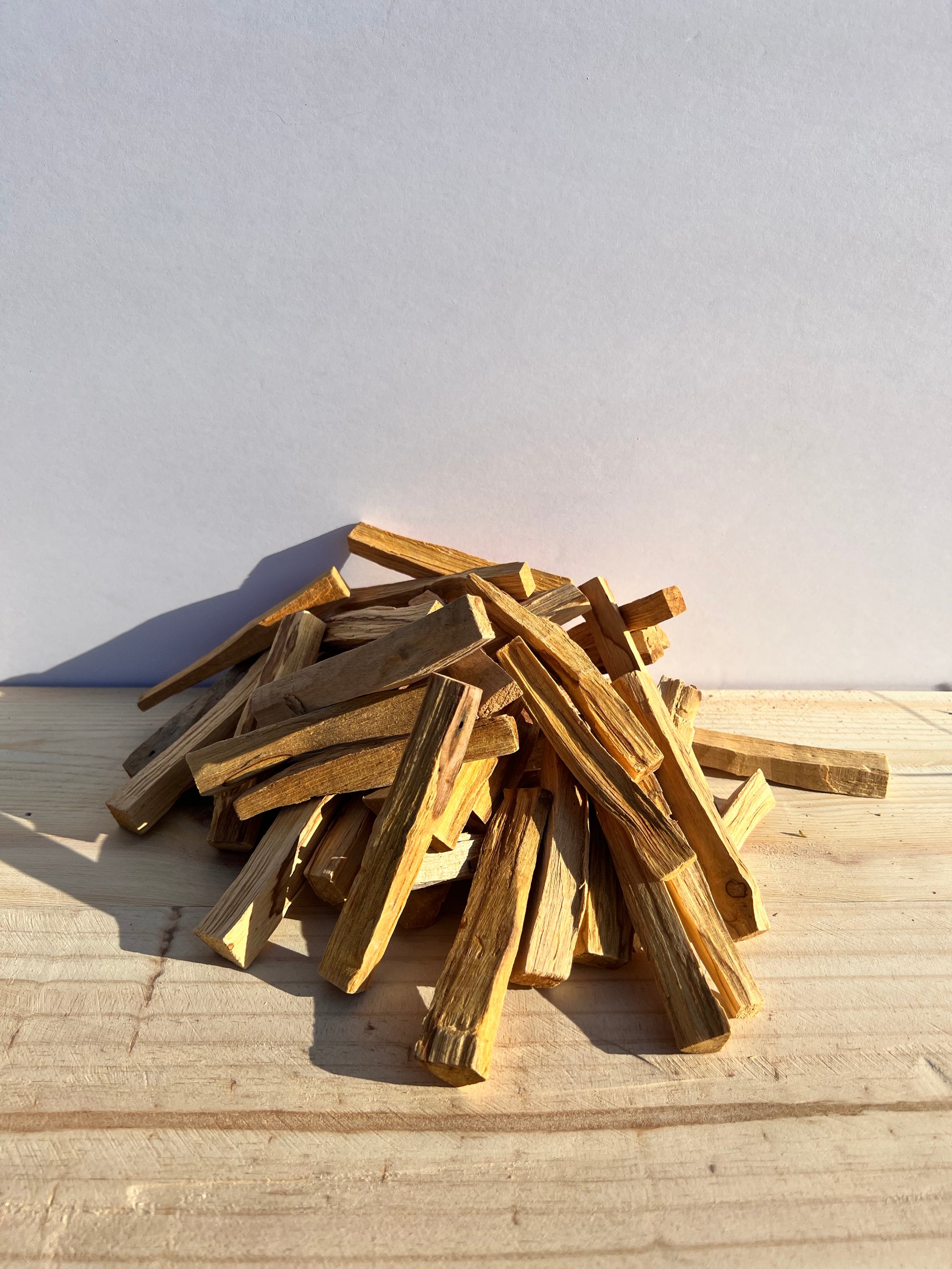Another view of a pile of palo santo sticks.