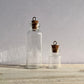 Large and small glass spell bottles with eyelet hooks.