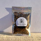 1/2 oz. of sifted cascara sagrada bark, in a holographic zip-top bag, featuring a label of weight & contents.