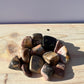 Variety of tumbled rhodonite stones