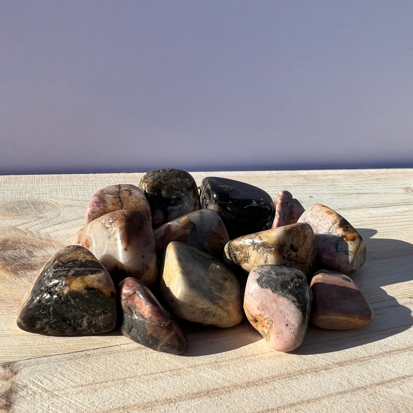 A pile of tumbled rhodonite